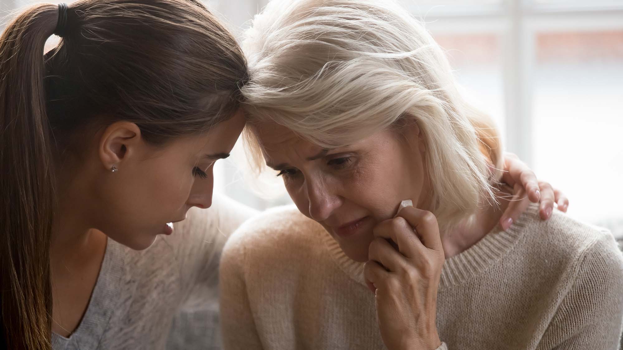 Young woman comforting a relative